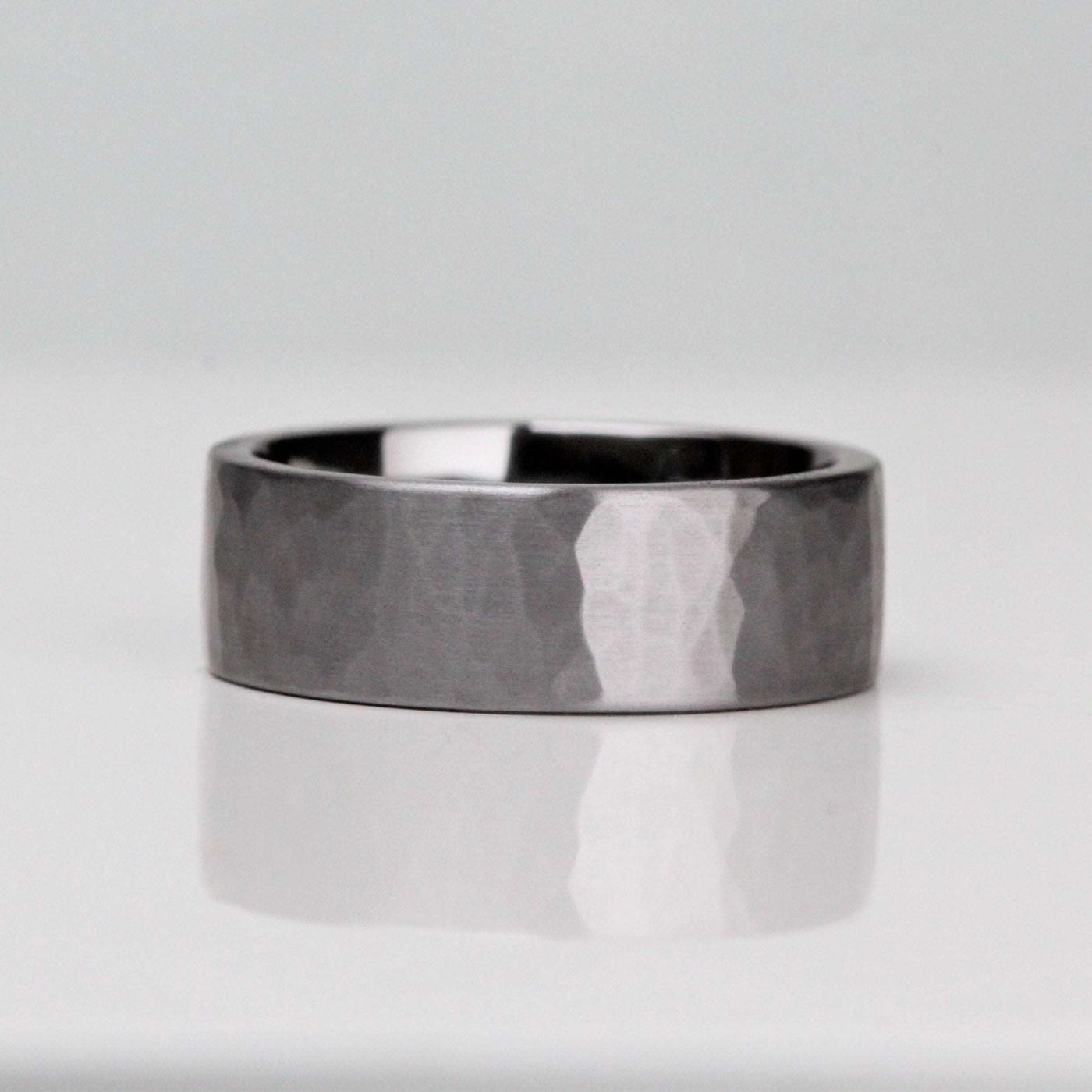 A mans Tantalum wedding ring. Gunmetal grey in 7mm width with a hammered and brushed/matt finish