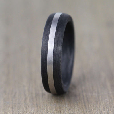 carbon fibre black wedding ring band with a palladium inlay. brushed finish 6mm wide court