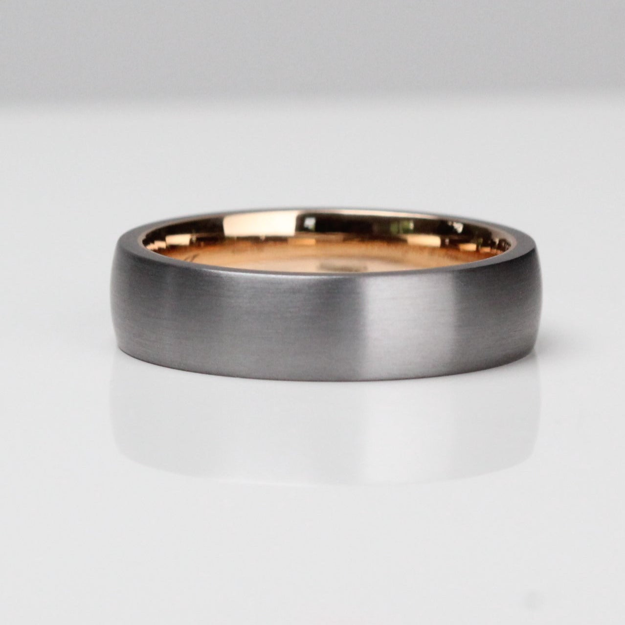 Tantalum wedding ring with a 14 karat rose gold liner. Comfort fit mens wedding band