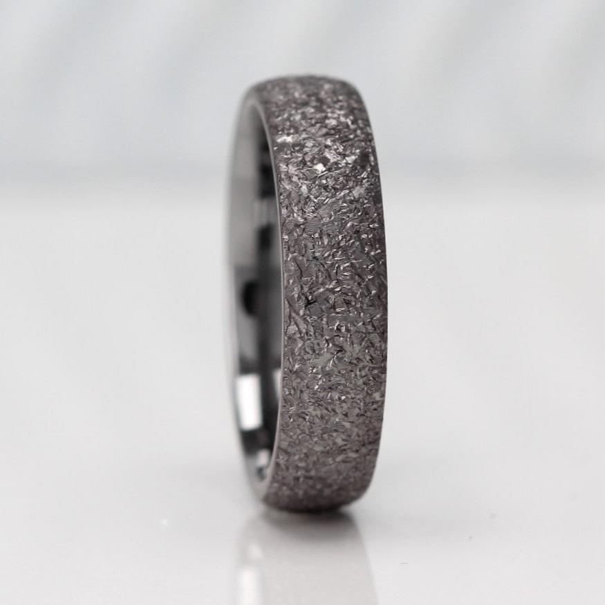 Men's 7mm wide court shape wedding ring crafted from tantalum, featuring a modern and durable design with a special asteroid finish—ideal for those seeking a unique and stylish alternative to traditional rings