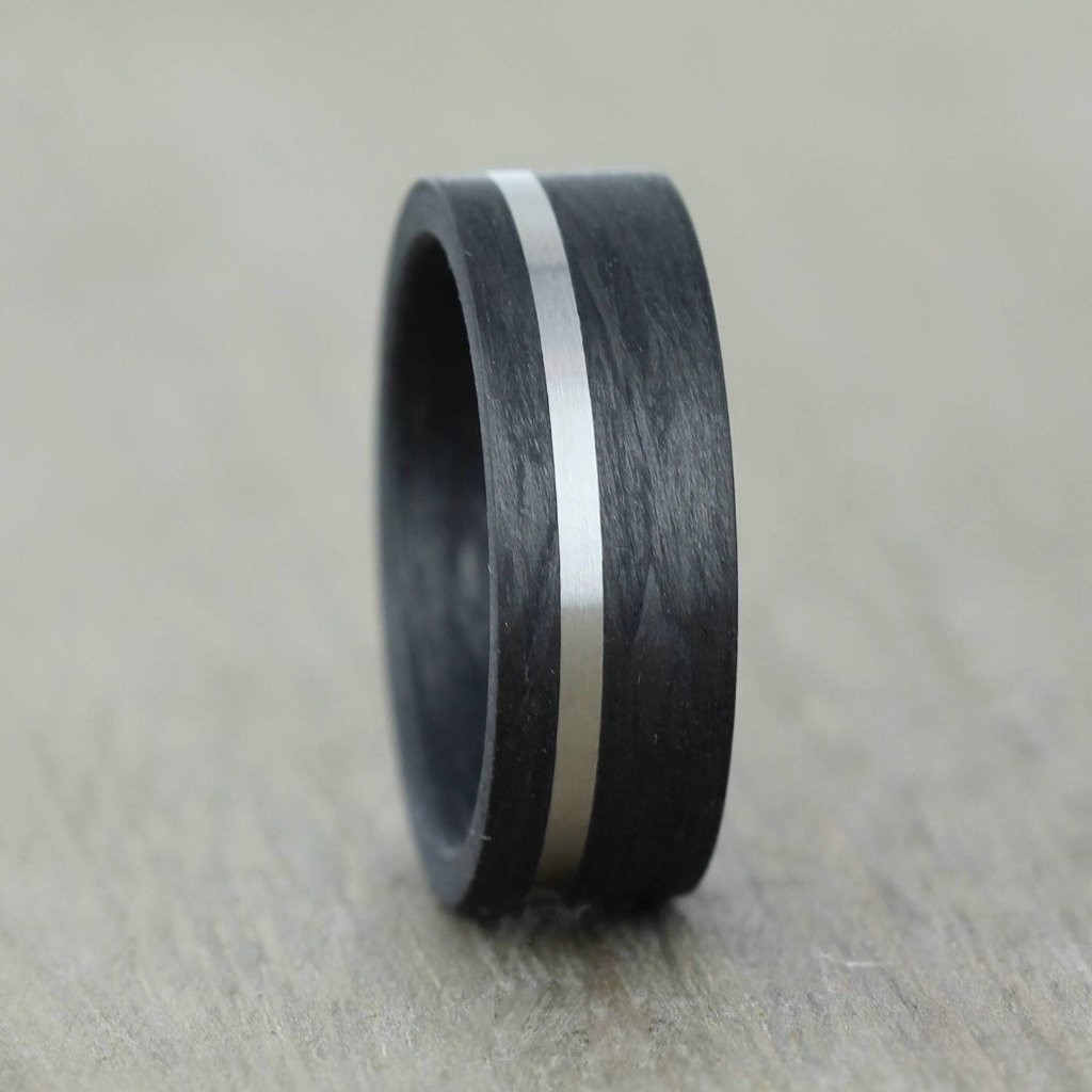 carbon fibre black wedding ring band with a palladium inlay. brushed finish 8mm wide flat court