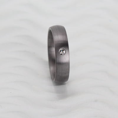Tantalum wedding ring band for woman with a diamond in brushed satin finish